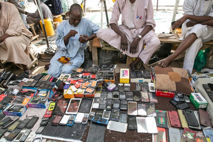 Street vendors display used mobile phone handsets for sale at Jagwal Electronics Market in Maiduguri, Nigeria.